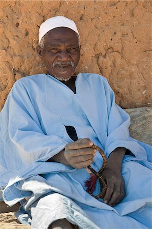 simsearch:400-05910051,k - Mali,Dogon Country. An old man,prayer beads in hand,rests near the mosque at Songho. Stock Photo - Rights-Managed, Code: 862-03364180