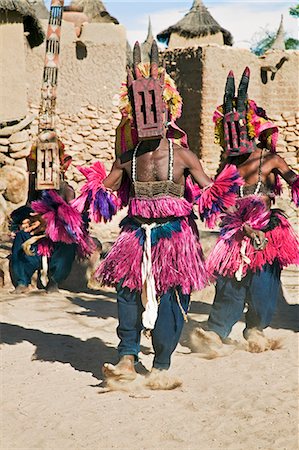 simsearch:400-06076338,k - Mali,Dogon Country,Tereli. Masked dancers wearing the buffalo mask performs at the Dogon village of Tereli. Tereli is situated among rocks at the base of the spectacular 120-mile-long Bandiagara escarpment. The mask dance is staged at funeral ceremonies to appease the dead and speed them on their way to the ancestral world. Stock Photo - Rights-Managed, Code: 862-03364214