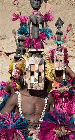 simsearch:400-06099430,k - Mali,Dogon Country,Tereli. Masked dancers wearing the satimbe mask perform at the Dogon village of Tereli. This mask honours the primordial woman who is said to have discovered the original Dogon masks. The mask dance is staged at funeral ceremonies to appease the dead and speed them on their way to the ancestral world. Stock Photo - Rights-Managed, Code: 862-03364212