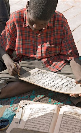 simsearch:862-03437232,k - Mali,Timbuktu. A young boy copies Arabic on a wooden 'slate' in Timbuktu. Since ancient times,Timbuktu has been a place of Islamic learning. There are numerous madrasa there to this day. Stock Photo - Rights-Managed, Code: 862-03364241