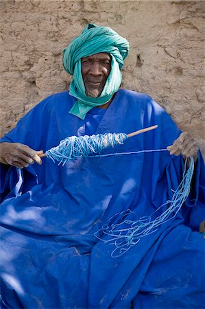 simsearch:862-03437232,k - Mali,Niger Inland Delta. An old man twisting polypropylene to make twine for fishing nets. Stock Photo - Rights-Managed, Code: 862-03364271