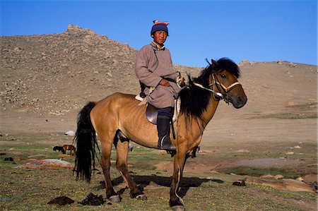 steppe - Mongolia,Khovd (also spelt Hovd) aimag (region),Mongolian man on ahorse. Stock Photo - Rights-Managed, Code: 862-03364512