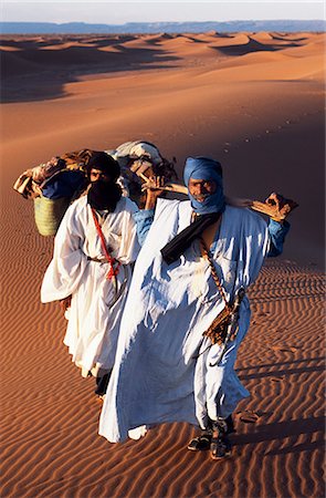 sahara camel - Berber tribesmen lead their camels through the sand dunes of the Erg Chegaga,in the Sahara region of Morocco. Stock Photo - Rights-Managed, Code: 862-03364595