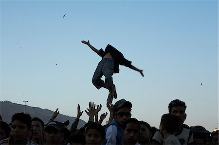 rhythm - Morocco,Fes. With the swifts soaring in the evening sky,young Moroccans enjoy a free Hip-Hop concert,during the Fes Festival of World Sacred Music,in the Place Boujloud. Stock Photo - Rights-Managed, Code: 862-03364807