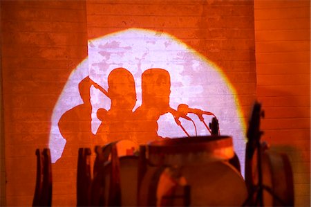 red music - Morocco,Fes. Shadows of musicians and drums are thrown against the ancient walls of the Bab Makina during the Fes Festival of World Sacred Music. Stock Photo - Rights-Managed, Code: 862-03364816