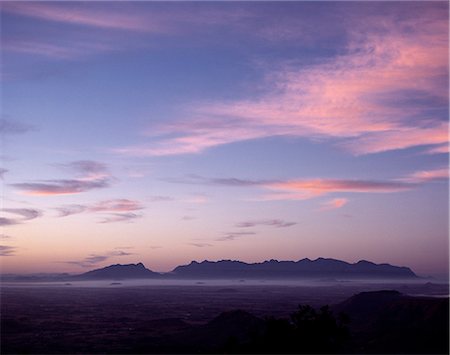 simsearch:862-03355195,k - Sunset over Mount Mulanje (9,840 feet) from the Zomba Plateau. Mulanje is the highest point in Malawi and in all of Southern Africa north of Lesotho and the Drakensberg Mountains. Rising steeply from the surrounding plains,it is a place of great natural beauty. . Stock Photo - Rights-Managed, Code: 862-03365061