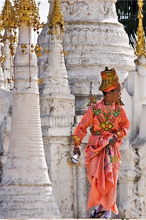 Myanmar. Burma. Lake Inle. A young novitiate passes an ornate Buddhist shrine during a ceremony in which the boy is inducted as a novice Buddhist monk. Stock Photo - Rights-Managed, Code: 862-03365142