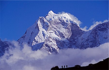 Climbers on ridge in the Dodh Koshir River Valley photograph a glacier clad Himalayan peak of the Everest Range Stock Photo - Rights-Managed, Code: 862-03365469