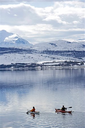 Norway,Tromso. Winter sea kayaking- a pair of kayakers paddle down a fjord near Tromso Stock Photo - Rights-Managed, Code: 862-03365611