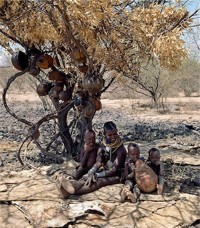 simsearch:862-03366124,k - When the Turkana form temporary stock camps in the dry season,they might have to move again in three or four days' time. Often,families have no time or inclination to build a temporary home. They will make do with a shady tree and sleep on skins spread out on the ground. Stock Photo - Rights-Managed, Code: 862-03366096