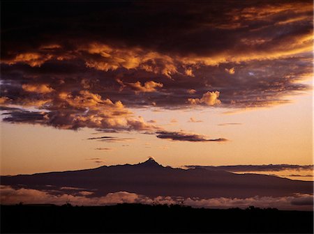 simsearch:862-03355195,k - Mount Kenya at sunrise. At 17,058 feet,Mount Kenya is Africa's second highest snow-capped mountain. Its peak is the hard plug of a huge ancient volcano that was active 5 million years ago. Stock Photo - Rights-Managed, Code: 862-03366229