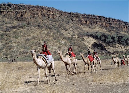 simsearch:841-03673550,k - Maasai men ride camels in the dry bush country at Olorgasailie,situated between Nairobi and Lake Magadi. Stock Photo - Rights-Managed, Code: 862-03366430