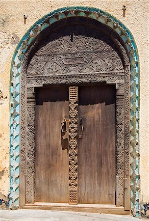 Kenya,Lamu Island,Lamu. A beautifully carved old wooden door in Lamu town. Lamu craftsmen are renowned for their carved doors. Stock Photo - Rights-Managed, Code: 862-03366745