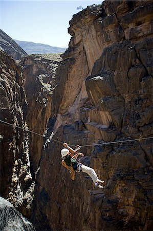 Oman,Western Hajar Mountains,Snake Canyon. A newly installed Via Ferrata ( Iron Way ) enables climbers and adventure seekers to cross otherwise inaccessible canyons and explore its mountains only a few hours from Muscat. British climber Justin Halls shows the way. Stock Photo - Rights-Managed, Code: 862-03360296