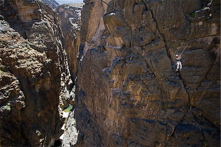 Oman,Western Hajar Mountains,Snake Canyon. A newly installed Via Ferrata ( Iron Way ) enables climbers and adventure seekers to cross otherwise inaccessible canyons and explore its mountains only a few hours from Muscat. British climber Justin Halls shows the way. Stock Photo - Rights-Managed, Code: 862-03360297