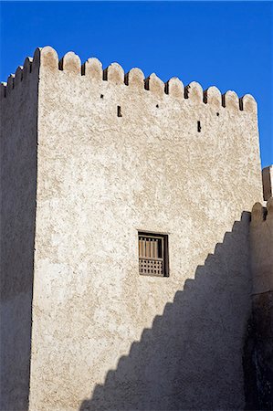 Oman,Musandam Peninsula,Khasab. A traditional mud built fort overlooking the bay to the front of the small town of Khasab famous for fishing and smuggling in small,fast boats,to and from Iran. Stock Photo - Rights-Managed, Code: 862-03360323