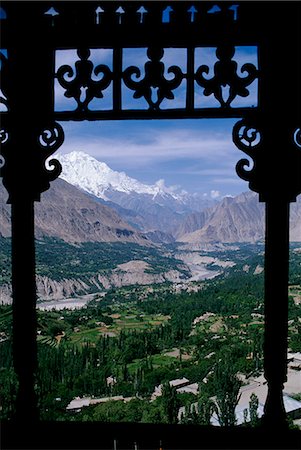 pakistan - Northwest Pakistan. The Hunza Valley facing south from the Baltit Fort along the Hunza River. The Peak of Rakaposhi in the Karakorums is visible in the distance Stock Photo - Rights-Managed, Code: 862-03360388