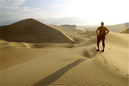 simsearch:862-03360742,k - A hiker looks out over the desert landscape near Huacachina in southern Peru. Stock Photo - Rights-Managed, Code: 862-03360550