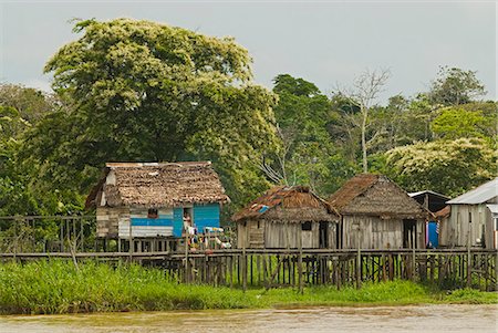 Peru,Amazon River. Traditional thatch huts built along the shore of the Amazon River. Stock Photo - Rights-Managed, Code: 862-03360628