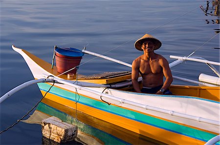 Philippines,Palawan,Puerto Princessa. Fisherman on a colourful banka fishing boat. Stock Photo - Rights-Managed, Code: 862-03360811