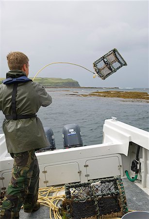simsearch:862-03361556,k - Benmore Estate ghillie,Donald Bissett,throws a lobster pot out of the boat into Loch na Keal Stock Photo - Rights-Managed, Code: 862-03361547