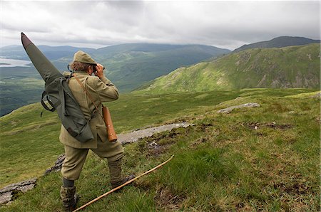 simsearch:862-03361556,k - Benmore Estate stalker,Neilson Bissett,on the hill stalking red deer. He carries binoculars,telescope,stalking rifle and walking stick. Stock Photo - Rights-Managed, Code: 862-03361554