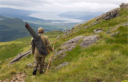 simsearch:862-03361556,k - Benmore Estate stalker,Neilson Bissett,on the hill stalking red deer. He carries binoculars,telescope,stalking rifle and walking stick. Stock Photo - Rights-Managed, Code: 862-03361552