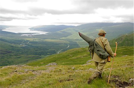 simsearch:862-03361556,k - Benmore Estate stalker,Neilson Bissett,on the hill stalking red deer. He carries binoculars,telescope,stalking rifle and walking stick. Stock Photo - Rights-Managed, Code: 862-03361553
