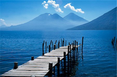 simsearch:862-07495921,k - Fishing jetty on Lake Atitlan with volcanoes Toliman and Atitlan behind. Stock Photo - Rights-Managed, Code: 862-03437098
