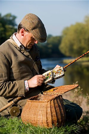 Wales,Wrexham. A fisherman selects a fly while salmon fishing on the River Dee Stock Photo - Rights-Managed, Code: 862-03437884