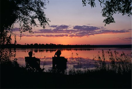 Zambia,Tongabezi Lodge,Zambezi River. Sundowners at Tongabezi,looking across the Zambezi river Stock Photo - Rights-Managed, Code: 862-03438010