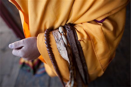 Bumthang, Bhutan. A clodes up of a monks arm with prayer beads and whip. Stock Photo - Rights-Managed, Code: 862-03710469