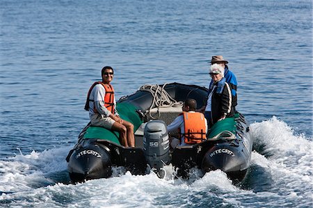 dingy - Galapagos Islands,   panga  or inflatable rubber dingy takes visitors back to the yacht from Genovese Island. Stock Photo - Rights-Managed, Code: 862-03711563