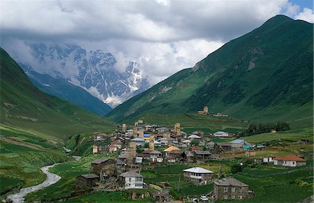 snow mountain trees river - Mt Shkhara,a 5068m peak on the frontier with Russia,dominates the skyline at Ushguli,reputedly Europe's highest permanently inhabited village. Stock Photo - Rights-Managed, Code: 862-03711576