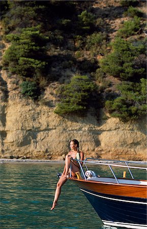 Girl sun-bathing on traditional wooden motor cruiser Stock Photo - Rights-Managed, Code: 862-03711682