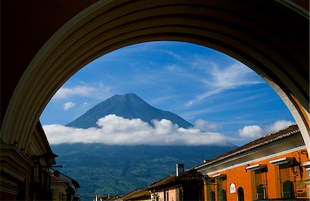 simsearch:862-07495921,k - The 3766 metre high Agua Volcano,one of three that dominate the skyline around Antigua,is framed by the arch of Santa Catalina convent. Stock Photo - Rights-Managed, Code: 862-03711719