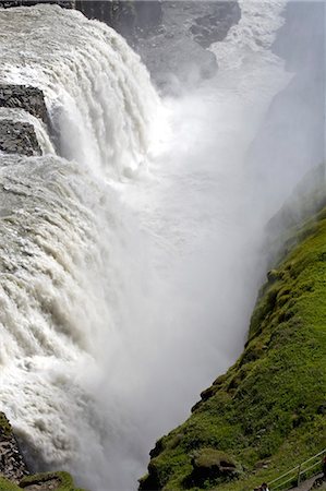 Iceland. Gullfoss (Golden Falls) is a magnificient 32m high double waterfall on the White River (Hvíta). The flow of the river from the regular rains and the glacial runoff,particularly in summer,makes it the largest volume falls in Europe. Stock Photo - Rights-Managed, Code: 862-03711822