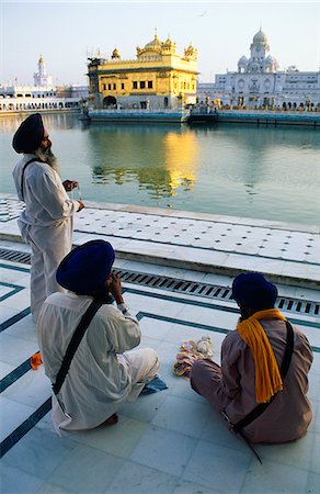 Silk pilgrims pause beside the Amrit Sarovar,the pool of Immortality-Giving Nectar,and the Golden Temple. Stock Photo - Rights-Managed, Code: 862-03711898