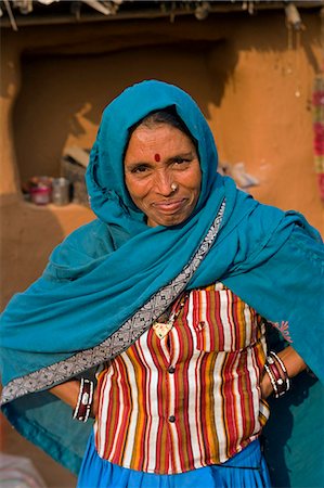 simsearch:862-03712011,k - India,Rajasthan,Jaipur,Sariska. The matriarch of a small farming household takes a break from preparing lunch to pose for the camera. Stock Photo - Rights-Managed, Code: 862-03711994