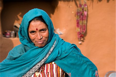 simsearch:862-03712011,k - India,Rajasthan,Jaipur,Sariska. The matriarch of a small farming household takes a break from preparing lunch to pose for the camera. Stock Photo - Rights-Managed, Code: 862-03711993