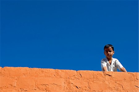 simsearch:862-03711843,k - India,Rajasthan,Jaisalmer. A small boy looks out over the balcony of his house into the alleyway below. Stock Photo - Rights-Managed, Code: 862-03712029