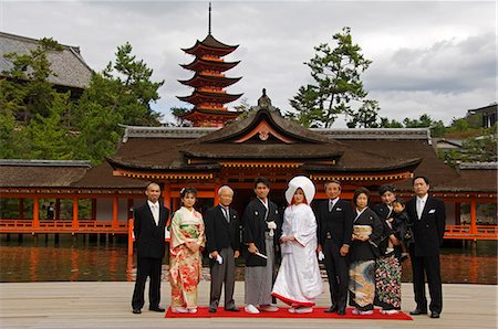 Japan,Honshu Island,Hiroshima Prefecture,Miyajima Island,Itsukushima Shrine. Wedding ceremony family portrait in front of a 15th Century pagoda. Stock Photo - Rights-Managed, Code: 862-03712539