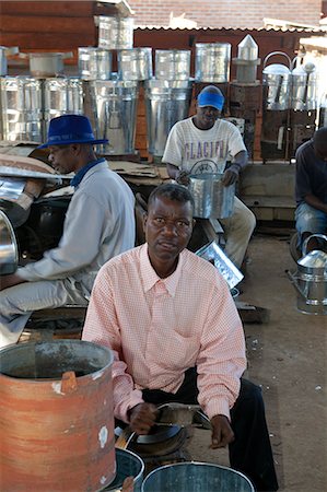 Malawi, Zomba. In the covered market, a group of blacksmiths work as a team to produce domestic holdhold goods Stock Photo - Rights-Managed, Code: 862-03713049