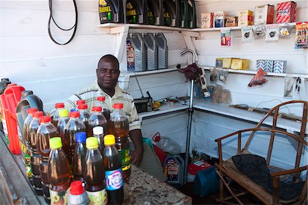 simsearch:862-06543210,k - Malawi, Zomba. In the market area, selling motor oils and spare parts, a shop owner relaxes behind his counter. Stock Photo - Rights-Managed, Code: 862-03713050