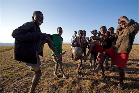 friends playing football - Malawi, Lilongwe, Ntchisi Forest Reserve. The local young football team show off their ball control skills Stock Photo - Rights-Managed, Code: 862-03713082