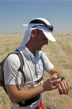 running a marathon - Namibia, Namib Desert, A runner competing in the Namibia Ultra Marathon from Brandberg Mountain to the Skeleton Coas. Stock Photo - Rights-Managed, Code: 862-03713117