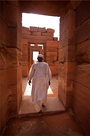 sudan - Sudan, Nagaa. The solitary guide at the remote ruins of Nagaa walks through the ruins. Stock Photo - Rights-Managed, Code: 862-03713649