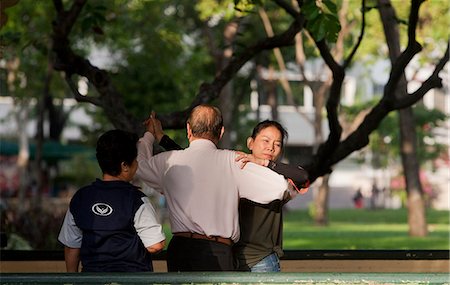 elderly exercise - People exercising in Lumpini Park in Bangkok. Lumphini Park (also Lumpini or Lumpinee) is a 140-acre (0.57 km2) park in Bangkok, Thailand. Stock Photo - Rights-Managed, Code: 862-03713847