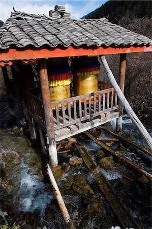 simsearch:862-05997261,k - China, Sichuan Province, Jiuzhaigou National Park, Unesco Site, prayer wheels being turned by the flow of river water Stock Photo - Rights-Managed, Code: 862-03736486