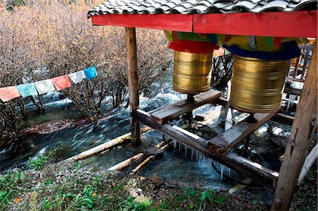 simsearch:862-05997261,k - China, Sichuan Province, Jiuzhaigou National Park, Unesco Site, prayer wheels being turned by the flow of river water Stock Photo - Rights-Managed, Code: 862-03736487